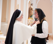 Mother places the Dominican pin on each postulant, which marks the beginning of their postulancy.