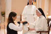 Mother gives each piece of the habit to the postulant with a brief statement of the significance of that clothing.