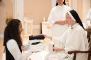 Mother gives each piece of the habit to the postulant with a brief statement of the significance of that clothing.