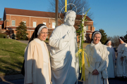 December 8, 2021, the Solemnity of the Immaculate Conception of the Blessed Virgin Mary, a prayer service was held in the afternoon. Workers on the roof project were invited to attend. Here, Mother Anna Grace (right) and Sister Anne Catherine pose for a photograph near the statue of St. Joseph before it is lifted by crane to the roof.