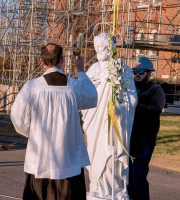 Father Chrismer blesses the St. Joseph statue and those present for the ceremony.