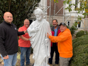 Those who took part in the restoration of the St. Joseph statue stop for a photograph before rolling the statue into the exonarthex of the St. Cecilia Chapel.