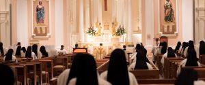 Bishop Spalding and the Community kneel in prayer during the Closing of Forty Hours Devotion in the St. Cecilia Chapel