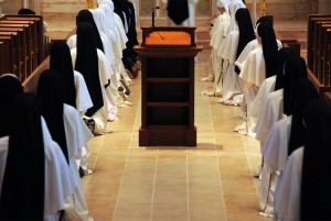 Sister kneeling in center aisle during Salve Regina