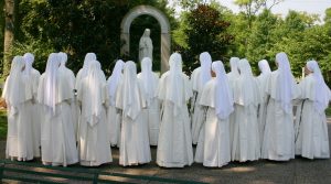 Novices pray the rosary at the grotto
