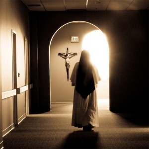 Dominican Sister walking down cloister hallway
